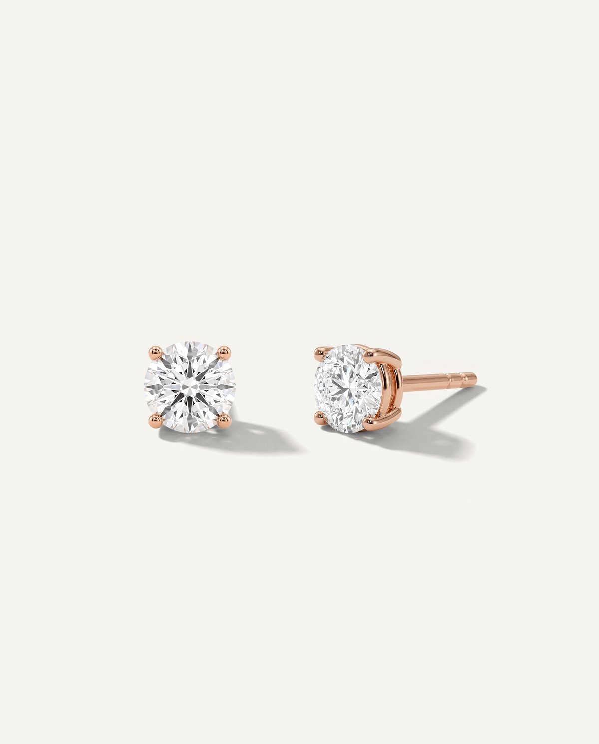Round lab-grown diamond stud earrings in rose gold, front and side view | MET-RE-0004-M08