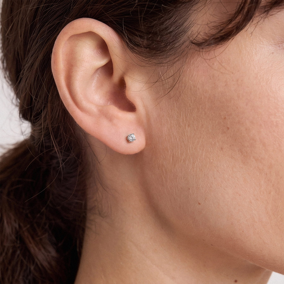 Lab-grown diamond stud earrings worn for styling; additional jewelry is not included | MET-RE-0004-M17