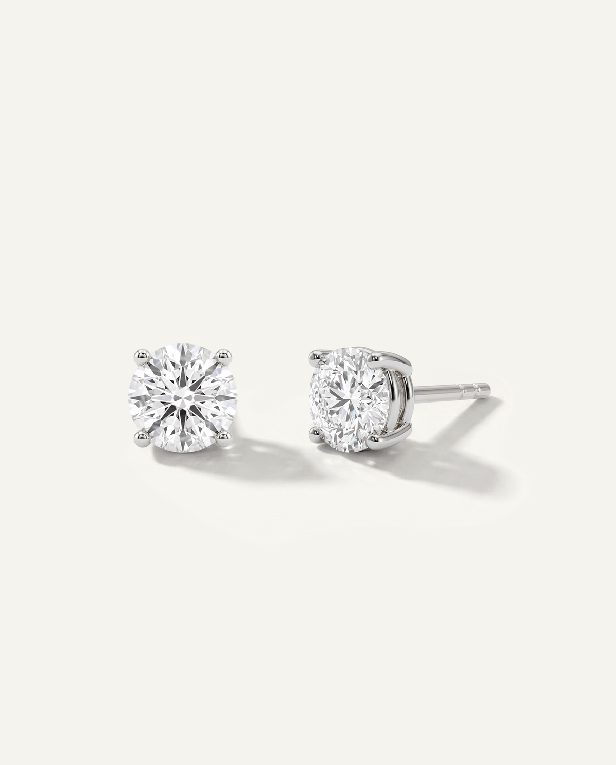 Round lab-grown diamond stud earrings in white gold, front and side view | MET-RE-0004-M22