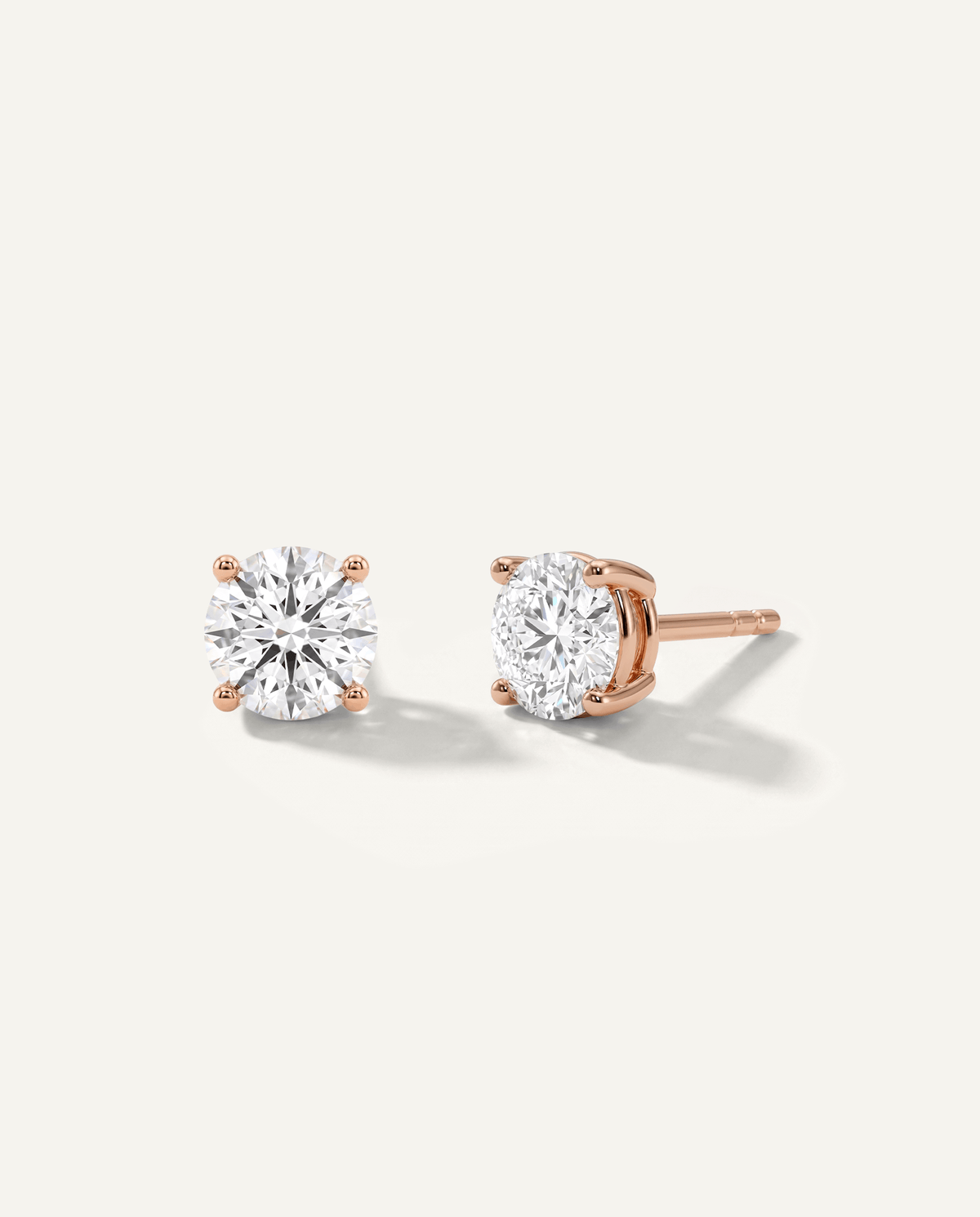 Round lab-grown diamond stud earrings in rose gold, front and side view | MET-RE-0004-M27