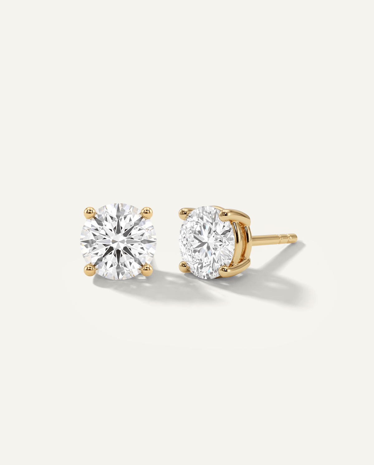 Round lab-grown diamond stud earrings in yellow gold, front and side view | MET-RE-0005-M06