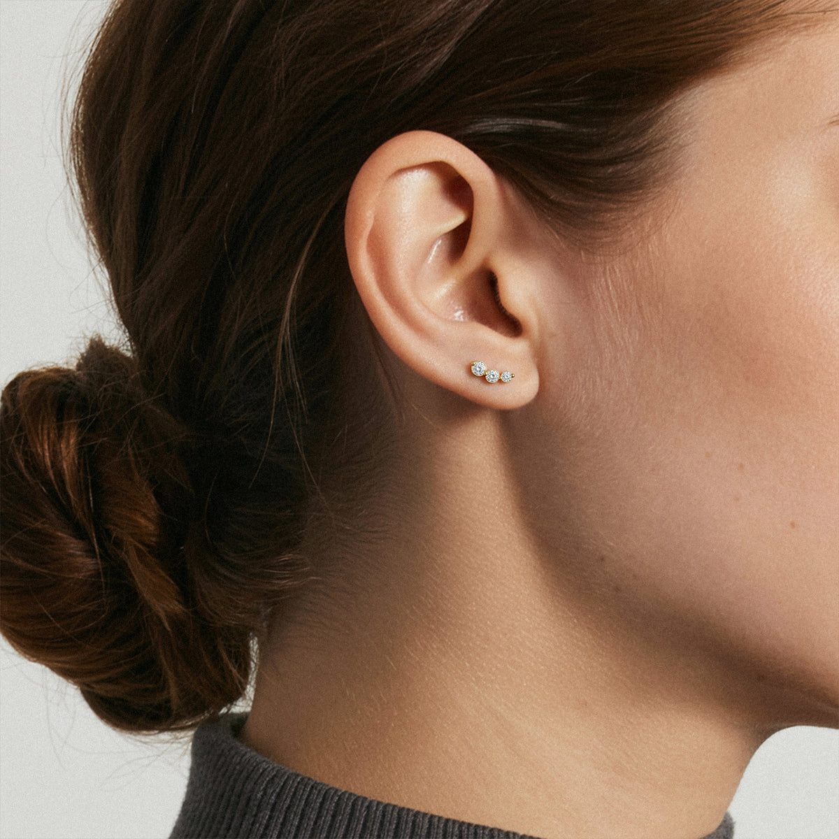Graduated Curved Three-Stone Lab-Grown Diamond Earrings worn for styling | MET-RE-0019-M04