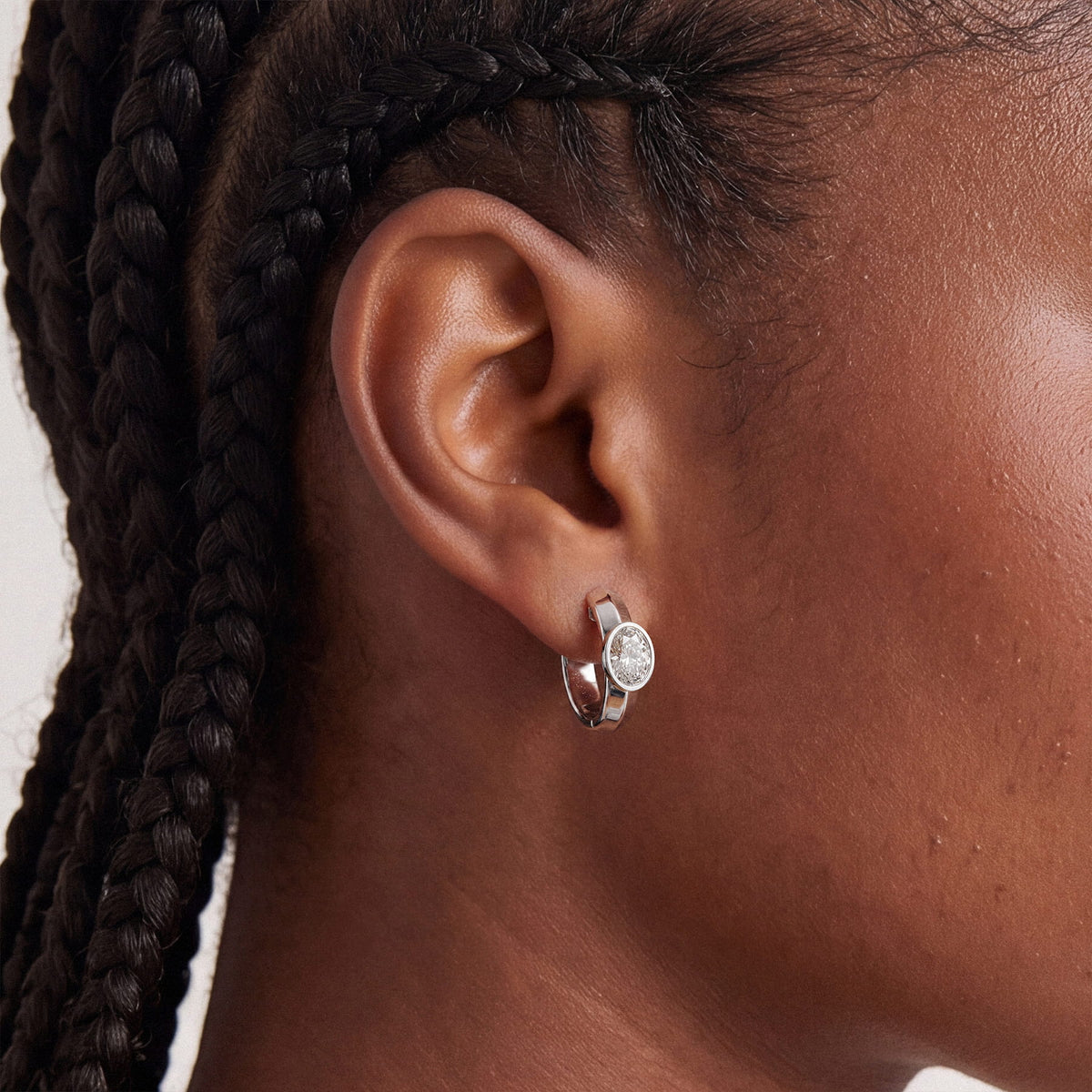 Oval Bezel-Set Lab-Grown Diamond Huggie Hoop Earrings worn for styling | MET-RE-0024-M08