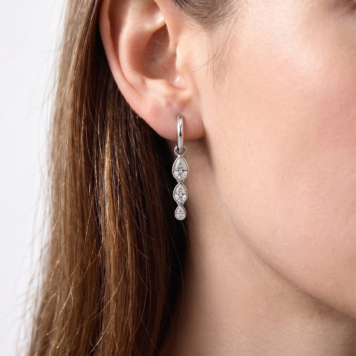 Triple Pear Bezel Lab-Grown Diamond Dangle Huggie Earrings worn for styling | E043-M04